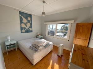 a bedroom with a bed and a window at Lorne Haven in Lorne