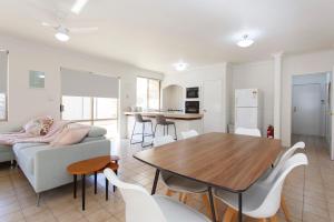 a living room with a table and a couch at Living on Lennard - Pet friendly house close to CBD in Perth