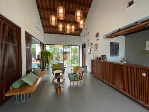 a living room with a couch and chairs in it at Hoian Tranquil Lodge - Chon Binh Yen in Hoi An