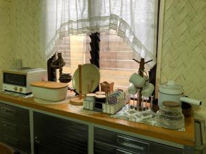 a kitchen counter with a sink and a microwave at Hiraya Homestay Coron in Coron +97 photos