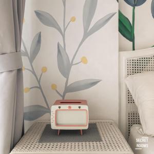a small radio sitting on a bed in a bedroom at Gateway Pasteur Apartment by Secret Rooms in Bandung