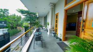 a balcony with tables and chairs on a building at Darmo Residence in Bandung
