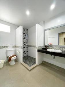 a bathroom with a toilet and a sink and a shower at S.B.Living Place in Phuket
