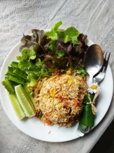 a plate of food with rice and vegetables on a table at Samui Camping Farm in Laem Sor