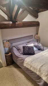a bedroom with a bed with two pillows on it at Maison de charme au cœur des vignes du Beaujolais in Saint-Georges-de-Reneins