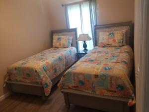 a bedroom with two beds and a window at Home Sweet Home in Fort Myers
