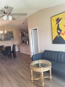 a living room with a blue couch and a table at Home Sweet Home in Fort Myers