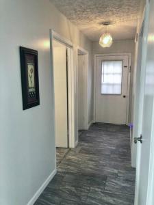 an empty hallway of a home with a room with a tile floor at Trestle Creek Farm- farmhouse suite in Bloomington
