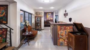 a living room with a room with paintings on the walls at VIOLETA HOTEL Boutique in Artigas