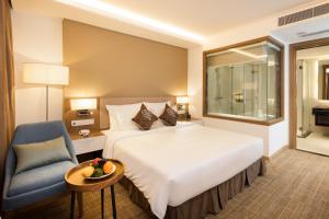 Postel nebo postele na pokoji v ubytování Comodo Nha Trang Hotel