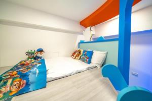 Postelja oz. postelje v sobi nastanitve 松楓親子民宿Songfeng Family B&B