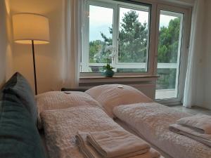 a living room with a couch and two windows at 4-Zimmer-Ferienwohnung, modern, Küche, WLAN, Netflix in Castrop-Rauxel +2 photos