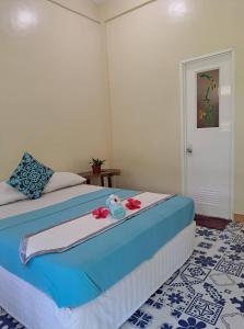 a bedroom with a bed with flowers on it at Happy's Homestay in Boracay
