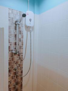 a shower with a shower head in a bathroom at Near boxing center, 1BR apartment, Sofa bed, Wifi in Chalong 