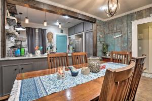 a dining room with a table and a kitchen at Historic Galveston Home Walkable Neighborhood! in Galveston