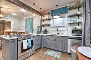 a kitchen with stainless steel appliances and a table at Historic Galveston Home Walkable Neighborhood! in Galveston +16 photos