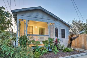 a tiny house with a porch in a garden at Historic Galveston Home Walkable Neighborhood! in Galveston