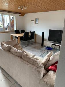 a living room with a couch and a tv at Sunny private Apartment in an amazing valley in Wila