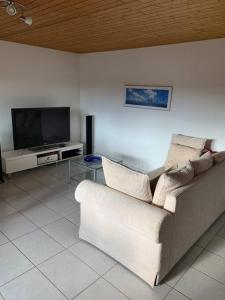 a living room with a couch and a tv at Sunny private Apartment in an amazing valley in Wila
