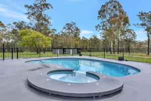 a swimming pool in a park with a fence at Kitchener Country Estate with Pool Hot Tub on private acres that sleeps up to 18 in Kitchener