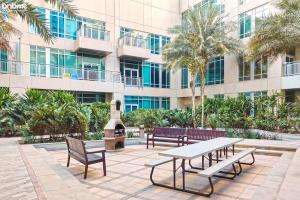 a group of benches and a table in front of a building at bnbmehomes - Duplex Living walk to Burj K and Dubai Mall - L313 in Dubai