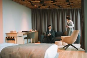 a man and a woman standing in a living room at SNOW PEAK FIELD SUITE SPA HEADQUARTERS 