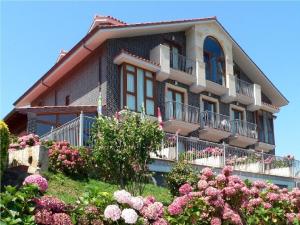 a large house with flowers in front of it at Hotel Azul de Galimar in San Vicente de la Barquera +39 photos