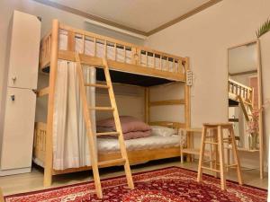 a bedroom with two bunk beds with a ladder at SOYA`S HOUSE in Busan
