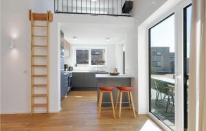 a kitchen with a counter and two stools at Awesome Home In Lembruchdümmer See in Lembruch +42 photos