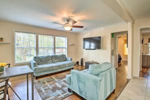 a living room with two couches and a table at Forest Park Home with Porch and Large Fenced Yard in Forest Park