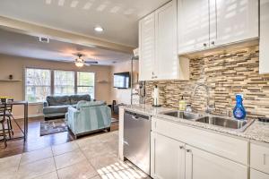 a kitchen with a sink and a living room at Forest Park Home with Porch and Large Fenced Yard in Forest Park
