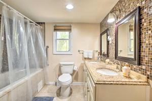 a bathroom with a toilet and a sink and a shower at Forest Park Home with Porch and Large Fenced Yard in Forest Park +16 photos
