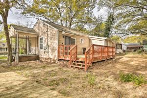 a house with a large deck and a house at Forest Park Home with Porch and Large Fenced Yard in Forest Park