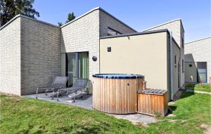 a house with a trash can and two chairs at Nice Home In Lembruchdümmer See in Lembruch +46 photos