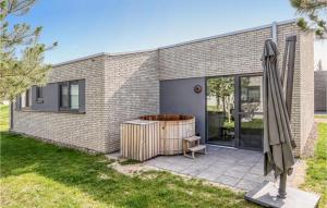 a brick house with a hot tub in the backyard at Stunning Home In Lembruch-dmmer See With Sauna in Lembruch