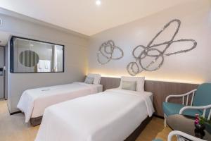 Postel nebo postele na pokoji v ubytování Pearl Hotel Phuket