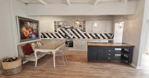 a kitchen with a table and a dining room at Fifty Five on Park in Graaff-Reinet