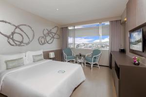 Postel nebo postele na pokoji v ubytování Pearl Hotel Phuket