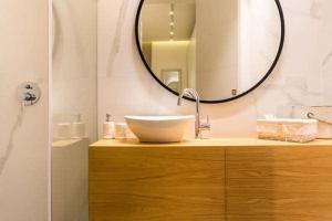 a bathroom with a sink and a mirror at Taverna by HolyGuest in Tel Aviv