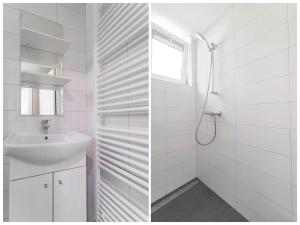 a white bathroom with a sink and a shower at Holiday Home in Gelderland near Den Bramel in Lochem +32 photos