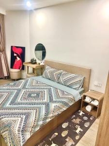 a bedroom with a bed with a rug on it at The Song Apartment Vung Tau Homestay Căn Hộ Biển in Vung Tau