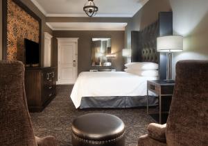 a hotel room with a bed and a tv at Le Pavillon New Orleans in New Orleans