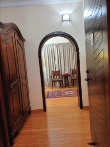 an archway leading into a living room with a door at Al Khariss Hotel in Doha