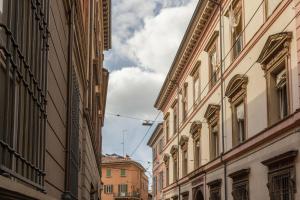 an alley between two buildings in a city at De'Carbonesi, Bologna by Short Holidays in Bologna