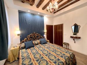 a bedroom with a bed with a blue and gold bedspread at Cà Nova in Venice