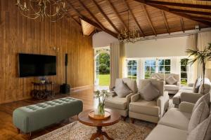 a living room with a couch and a tv at The Lavender House by Reveal in Kandy