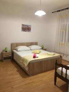 a bedroom with a bed with a stuffed animal on it at Apartment in Slatine with terrace, air conditioning, WiFi, washing machine (4782-3) in Slatine