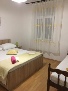 a bedroom with two beds and a window at Apartment in Slatine with terrace, air conditioning, WiFi, washing machine (4782-3) in Slatine