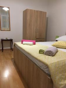 a bedroom with two beds and a wooden cabinet at Apartment in Slatine with terrace, air conditioning, WiFi, washing machine (4782-3) in Slatine
