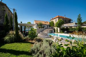 a backyard with a swimming pool and a house at Villa Lastva in Tivat